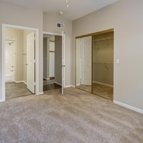 a bedroom with carpet and a fan