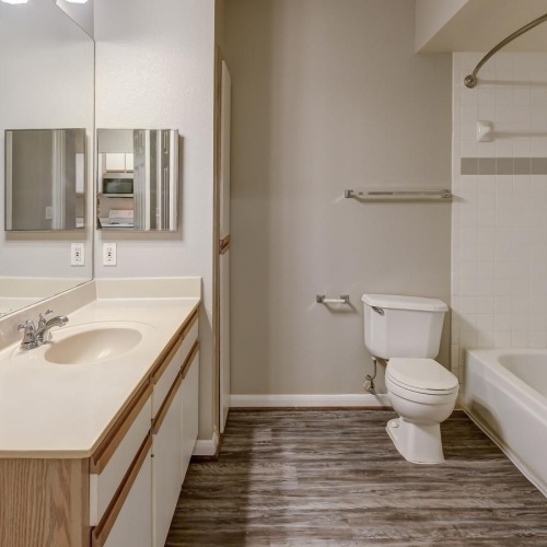 a bathroom with a tub, toilet and sink