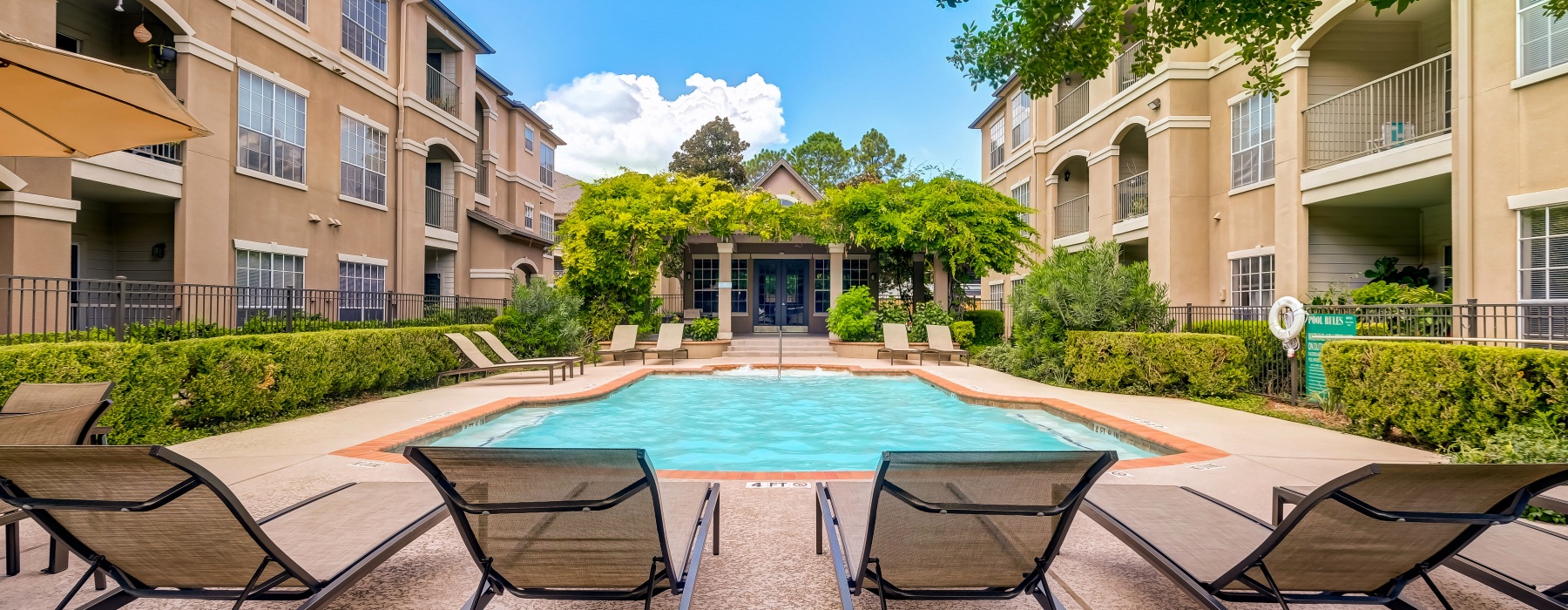 Resort-style swimming pool with lounge seating