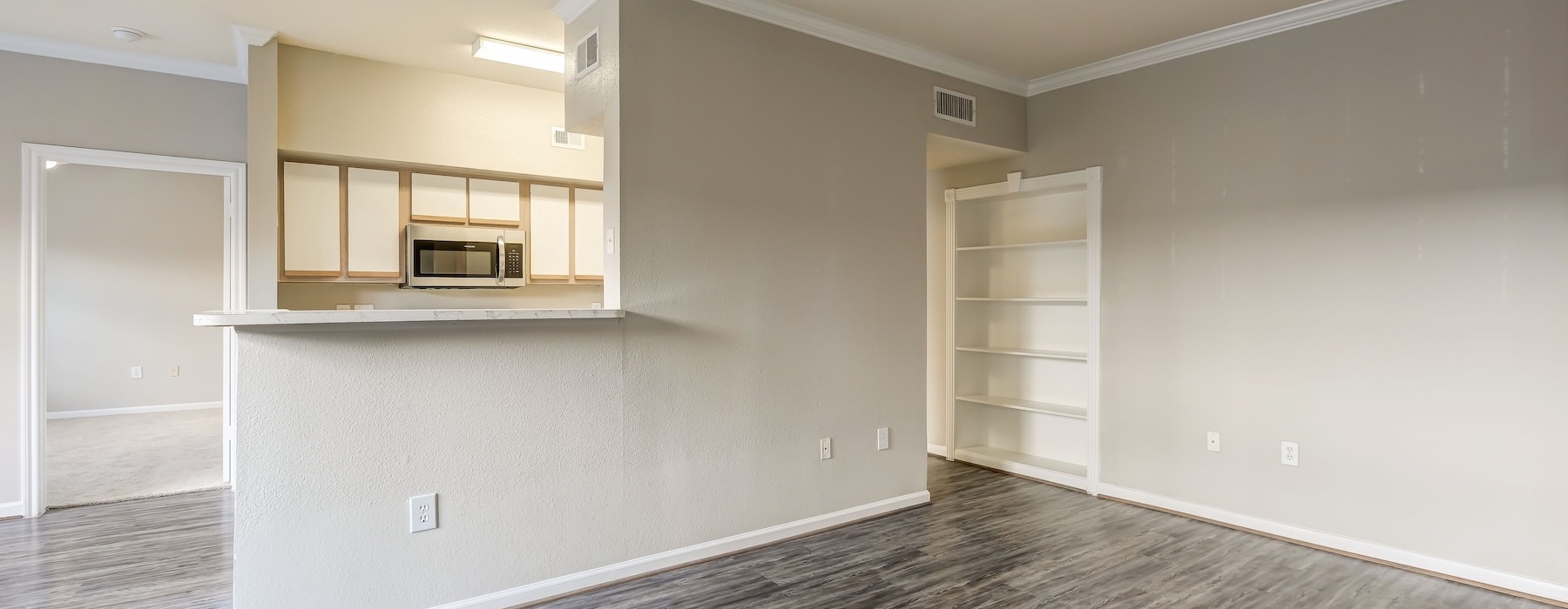 an empty living room with natural lighting