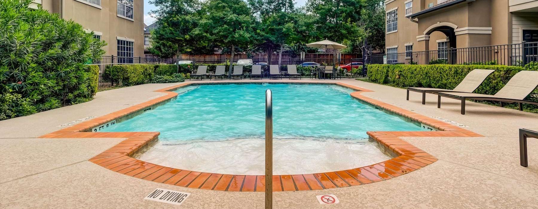 a swimming pool in a courtyard between buildings
