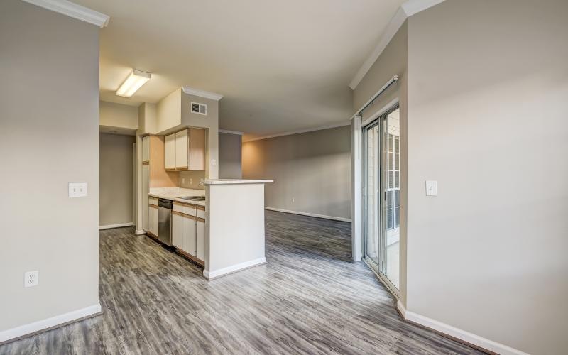 a kitchen and a living room with a sliding glass door